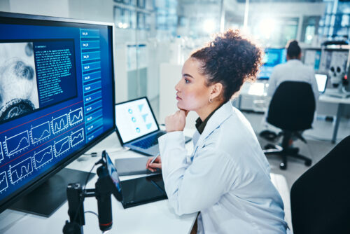 female researcher analyzing data in modern laboratory